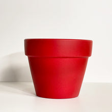 Load image into Gallery viewer, A red terracotta pot with a matte finish. The planter pot includes a drainage hole.
