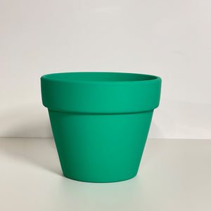 A green terracotta pot with a matte finish. The planter pot includes a drainage hole.