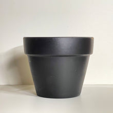 Load image into Gallery viewer, A black terracotta pot with a matte finish. The planter pot includes a drainage hole.
