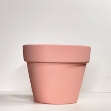 Load image into Gallery viewer, A pink terracotta pot with a matte finish. The planter pot includes a drainage hole.
